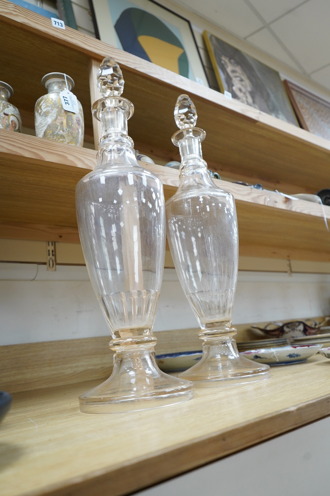 A pair of Victorian clear glass chemist display bottles and stoppers, 63cm high